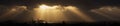 Sunrays bursting through stormy clouds panorama