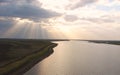 Sunrays through Clouds spreading over a River Royalty Free Stock Photo