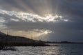 Sunrays through dark clouds above Trasimeno lake Umbria, Italy Royalty Free Stock Photo