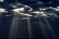 Sunrays through dark grey clouds