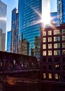 Sunrays extend over Chicago downtown during morning commute on a late February winter evening. El train passes over Chicago River. Royalty Free Stock Photo