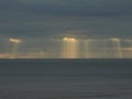 Sunrays through heavy clouds on the beach Royalty Free Stock Photo