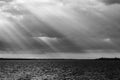 Sunrays at near sunset, with dark clouds in the background, above Trasimeno lake Umbria, Italy Royalty Free Stock Photo