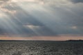 Sunrays at near sunset, with dark clouds in the background, above Trasimeno lake Umbria, Italy Royalty Free Stock Photo