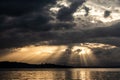 Sunrays at near sunset, with dark clouds in the background, above Trasimeno lake, Umbria, Italy Royalty Free Stock Photo