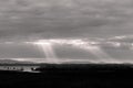 Sunrays at near sunset, with dark clouds in the background, above Trasimeno lake, Umbria, Italy Royalty Free Stock Photo