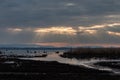 Sunrays at near sunset, with dark clouds in the background, above Trasimeno lake, Umbria, Italy Royalty Free Stock Photo