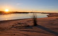 Sunrays and reeds at sunrise reflecting in the Santa Clara river / tidal inlet at McGrath State Park in Ventura California USA