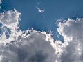 Sunrays shining through white clouds on blue sky background