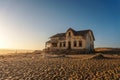 Sunrise above an abandoned house in Kolmanskop ghost town, Namibia Royalty Free Stock Photo