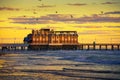 Sunrise above Daytona Beach Main Street Pier, Florida, with a flock of seagulls