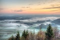 Sunrise above fields covered with morning mists