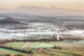 Sunrise above fields covered with morning mists