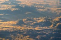 Sunrise above fluffy clouds from an airplane window with sunlight. Abstract nature texture background. Royalty Free Stock Photo