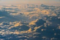 Sunrise above fluffy clouds from an airplane window with sunlight. Abstract nature texture background. Royalty Free Stock Photo