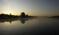 Sunrise above a river on foggy summer morning, the sky reflections in the water,  misty reflection in steaming water, Royalty Free Stock Photo