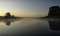 Sunrise above a river on foggy summer morning, the sky reflections in the water,  misty reflection in steaming water, Royalty Free Stock Photo