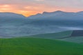 Sunrise on the agricultural wheat plains. Wheat field early in the morning at sunrise behind the mountain Royalty Free Stock Photo