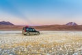 Sunrise at Atacama Desert and your Volcanos with a car
