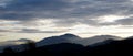 Sunrise in the austrian alps shining at mystic clouds up sleeping hilltops in styria