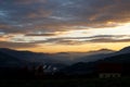 Sunrise in the austrian alps shining at mystic clouds up a sleeping valley in styria in the austrian alps