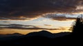 Sunrise in the austrian alps shining at mystic clouds up a sleeping valley in styria in the austrian alps Royalty Free Stock Photo