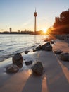 Sunrise on the banks of the river Rhine in Dusseldorf. The skyline of the city with the Rheinturm tower