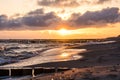 Sunrise at the beach of the baltic sea with seagull flying