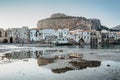 Sunrise on beach in Cefalu, Sicily, Italy, old town panoramic view with colorful waterfront houses, sea and La Rocca cliff. Royalty Free Stock Photo