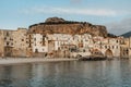 Sunrise on beach in Cefalu, Sicily, Italy, old town panoramic view with colorful waterfront houses, sea and La Rocca cliff. Royalty Free Stock Photo