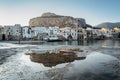 Sunrise on beach in Cefalu, Sicily, Italy, old town panoramic view with colorful waterfront houses, sea and La Rocca cliff. Royalty Free Stock Photo