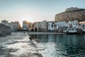 Sunrise on beach in Cefalu, Sicily, Italy, old town panoramic view with colorful waterfront houses, sea and La Rocca cliff. Royalty Free Stock Photo