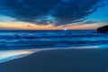 Sunrise at the beach with high cloud and boat with lights