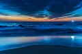 Sunrise at the beach with high cloud and boat with lights