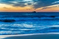 Sunrise at the beach with high cloud and boat with lights