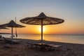 Sunrise on the beach with parasol overlooking the Red Sea in Hurghada, Egypt Royalty Free Stock Photo