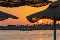 Sunrise on the beach with parasol overlooking the Red Sea in Hurghada, Egypt Royalty Free Stock Photo