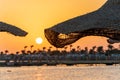 Sunrise on the beach with parasol overlooking the Red Sea in Hurghada, Egypt Royalty Free Stock Photo