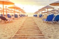 Sunrise and beach sunbed earl in the morning with burning sun Royalty Free Stock Photo