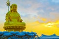 Sunrise behind buddha statue at Haedong Yonggungsa temple in Busan, Korea