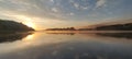 sunrise from behind the mountain against the backdrop of a beautiful river and forest Royalty Free Stock Photo