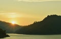 Sunrise behind mountain on river in Thailand Royalty Free Stock Photo