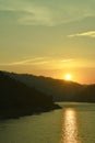 Sunrise behind mountain on river in Thailand Royalty Free Stock Photo