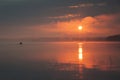 sunrise, big lake and fisherman on the boat. Horizontal landscape. Royalty Free Stock Photo