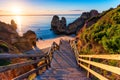 Sunrise at Camilo beach in Lagos, Algarve, Portugal. Wooden footbridge to the beach Praia do Camilo, Portugal. Picturesque view of Royalty Free Stock Photo