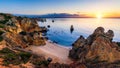 Sunrise at Camilo beach in Lagos, Algarve, Portugal. Wooden footbridge to the beach Praia do Camilo, Portugal. Picturesque view of