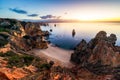 Sunrise at Camilo beach in Lagos, Algarve, Portugal. Wooden footbridge to the beach Praia do Camilo, Portugal. Picturesque view of