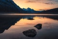 Sunrise on Canadian rockies with rocks on Medicine Lake at Jasper national park Royalty Free Stock Photo