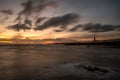 Sunrise at a chilly Cullercoats Bay in the north east of England, with Tynemouth Pier and the lighthouse in the distance Royalty Free Stock Photo