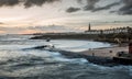 Sunrise at a chilly Cullercoats Bay in the north east of England, with Tynemouth Pier and the lighthouse in the distance Royalty Free Stock Photo